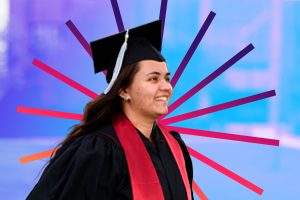 A young woman in graduation attire smiling