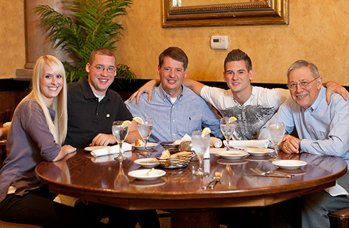 Five members of the Cappa legacy family dining together at a restaurant.