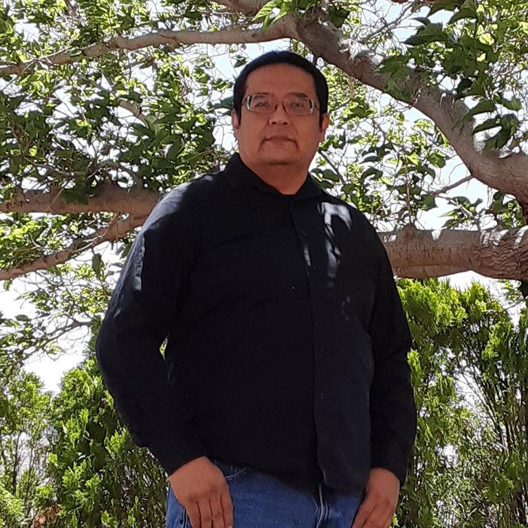Lawrence Alfred standing in front of a tree in Arizona.